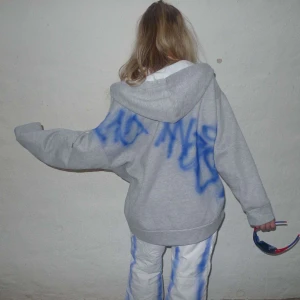 Grå zip hoodie  - Så snygg grå zip med grafittitryck! Färgen håller självklart i tvätten. Rogue_uf för mer info samt fler plagg! Personerna som bär hoodien är 165 samt 185 och bär normalt S!