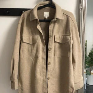 Höst/vår kappa  - Det är en jätte fin beig kappa ifrån H&M, ny utan prislapp. Köpt för 500 kr Anledning till att jag säljer är för jag aldrig använt den. 