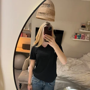 Svart t-shirt från Primark - Säljer en svart t-shirt från Primark i slim fit med stretch. Den har en v-ringad hals och korta ärmar💕