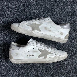 Golden goose Superstar  - Säljer ett par vita Golden goose Superstar i nyskick. Skorna är i storlek 39 eu och inget og medföljer vid köp. Vid minsta lilla fundering är det bara att höra av sig .