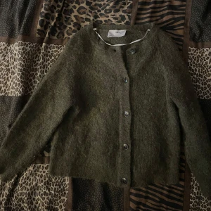 Olivgrön kofta från Selected Femme - Säljer en mysig olivgrön kofta från Selected Femme. Koftan har långa ärmar och knappar framtill. Passar bra till både jeans och kjol.