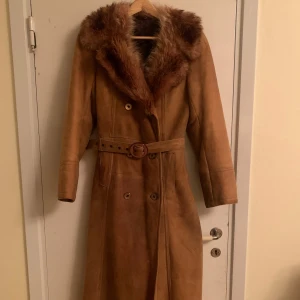 70-tals-kappa🍁 - Ascool mockakappa med päls runt kragen och varm ull på insidan. Bälte i midjan och knappar framtill. Perfekt för höst och vinter. Väldigt varm. Säljs pga för lite för liten men är så ledsen över det😩skriv privat för fler bilder eller vid frågor!