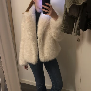 Vit pälsjacka - Säljer en supermysig vit pälsjacka som är perfekt för vintern. Den är fluffig och varm, med långa ärmar och en elegant look. Perfekt för att hålla sig varm och stilren under kalla dagar. Passar både till vardags och festliga tillfällen 😊☺️helt oanvänd med lappen kvar! 