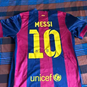 Säljer en autentisk FC Barcelona tröja från finalen i Berlin 2015. Den är randig i blått och rött med korta ärmar. Märkt med 'Messi 10' på baksidan och har Qatar Airways som sponsor. Perfekt för samlare eller fans! 🏆Storlek L men passar absolut inte då passformen är tight. Storlek M och S passar den perfekt för