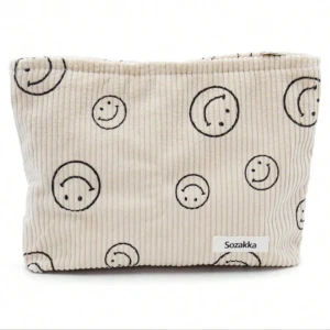 Beige necessär med smiley-mönster från Sozakka - Superfin beige necessär från Sozakka med glada smiley-ansikten. Perfekt för att förvara smink eller andra småsaker. Den är gjord i ett mjukt material och har en praktisk dragkedja. Måtten är 10,1 x 7 x 2,75 tum, vilket gör den lätt att ta med sig överallt.