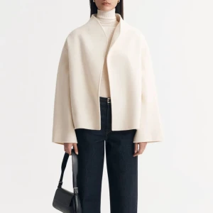 Soft goat kappa - Säljer en stilren vita kappa i mycket bra skick. Den har en minimalistisk design med en lös passform och långa ärmar. Perfekt för höst och vår, och funkar både till vardags och fest. Inga defekter och nypris är 5000 kr!