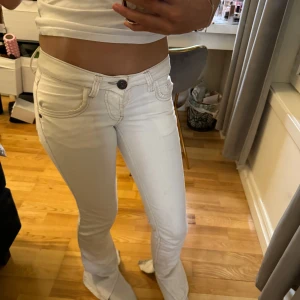 Vita lowwaist - Snygga vita jeansbyxor från denim wear med en tight passform. Byxorna har en klassisk femficksdesign och en knappgylf. Perfekta för en stilren look. De är uppklippta där nere eftersom jag tyckte de satt för skinny. Säljer för de har blivit för små! 