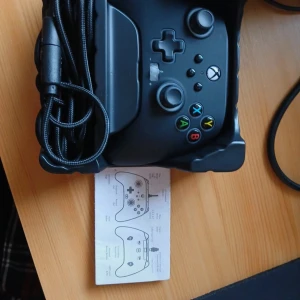 Svart Xbox-kontroll från PowerA - Säljer en svart Xbox-kontroll från PowerA, modell Spectra Infinity. Den har en trådbunden anslutning och är designad för Xbox. Kontrollen har färgglada knappar och en ergonomisk design för bekväm spelupplevelse. Perfekt för gaming!