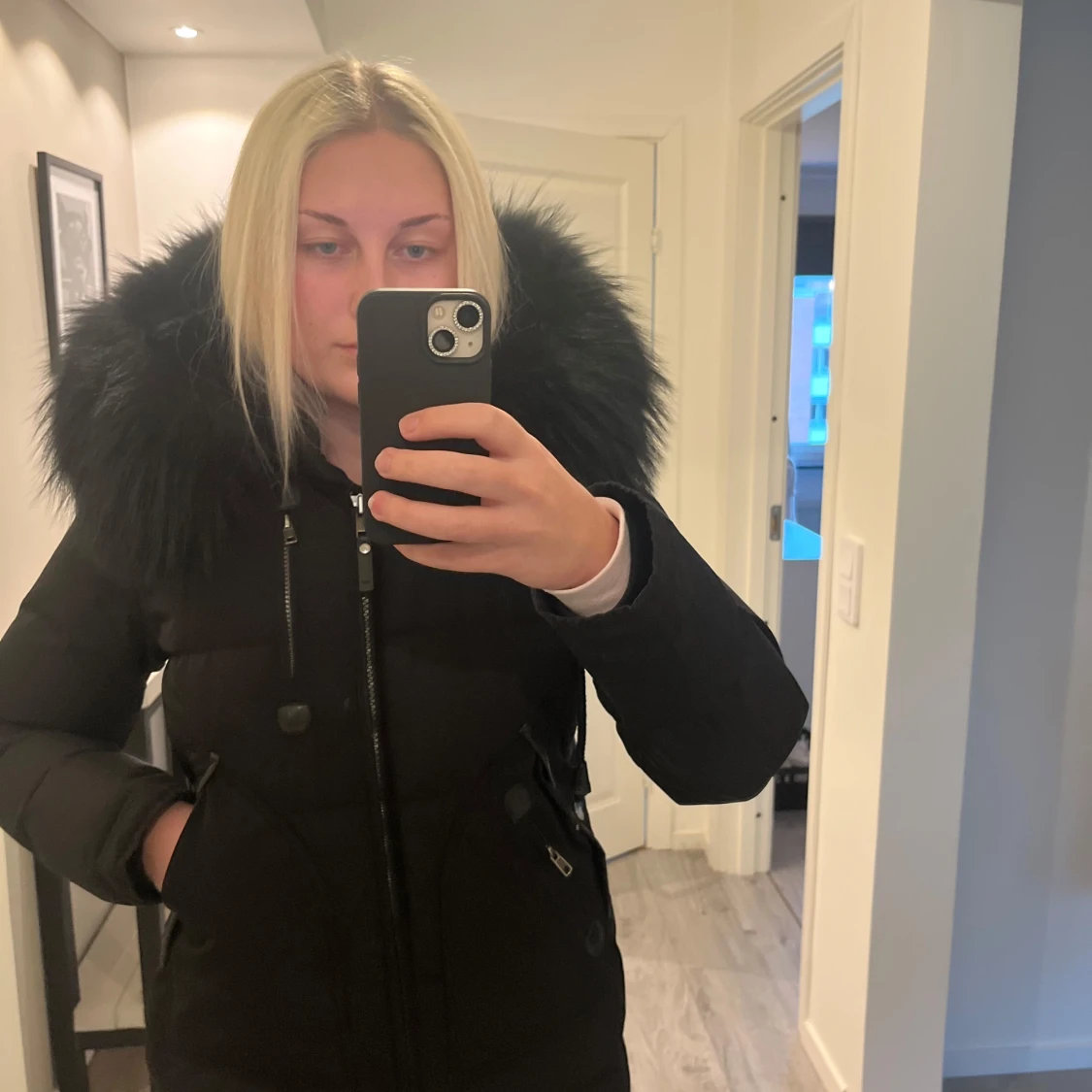 Svart dunjacka med pälsdetaljer