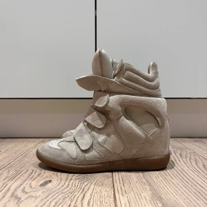 Isabel Marant sneakers - Säljer ett par snygga Isabel Marant beige sneakers i mocka med kilklack. Jag har inte kvitto.