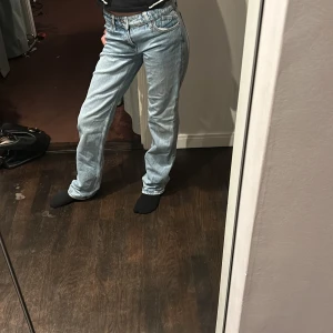 Blå jeans från Zara - Säljer ett par snygga blå jeans från Zara i storlek EUR 32. De har en klassisk straight fit och är perfekta för vardagsbruk. Jeansen är i bra skick och har en tidlös stil som passar till det mesta. Perfekta för både vår och höst!