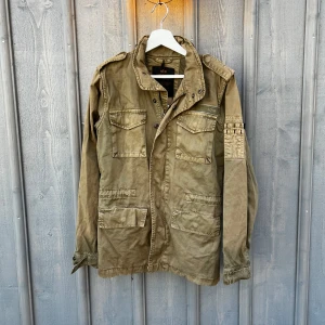 Field jacket - Säljer en olivgrön field jacket får alpha industries i bra skick. Perfekt för höst och vår. Jackan har långa ärmar och stängs med dragkedja och knappar. Strl: XS. Fråga vid funderingar. Pris kan diskuteras!