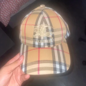 Burberry keps - Kepsen är lite använd men annars i helt nytt skick med inga skador. Storleken kan man ändra, e du intresserad så är de bara att skriva