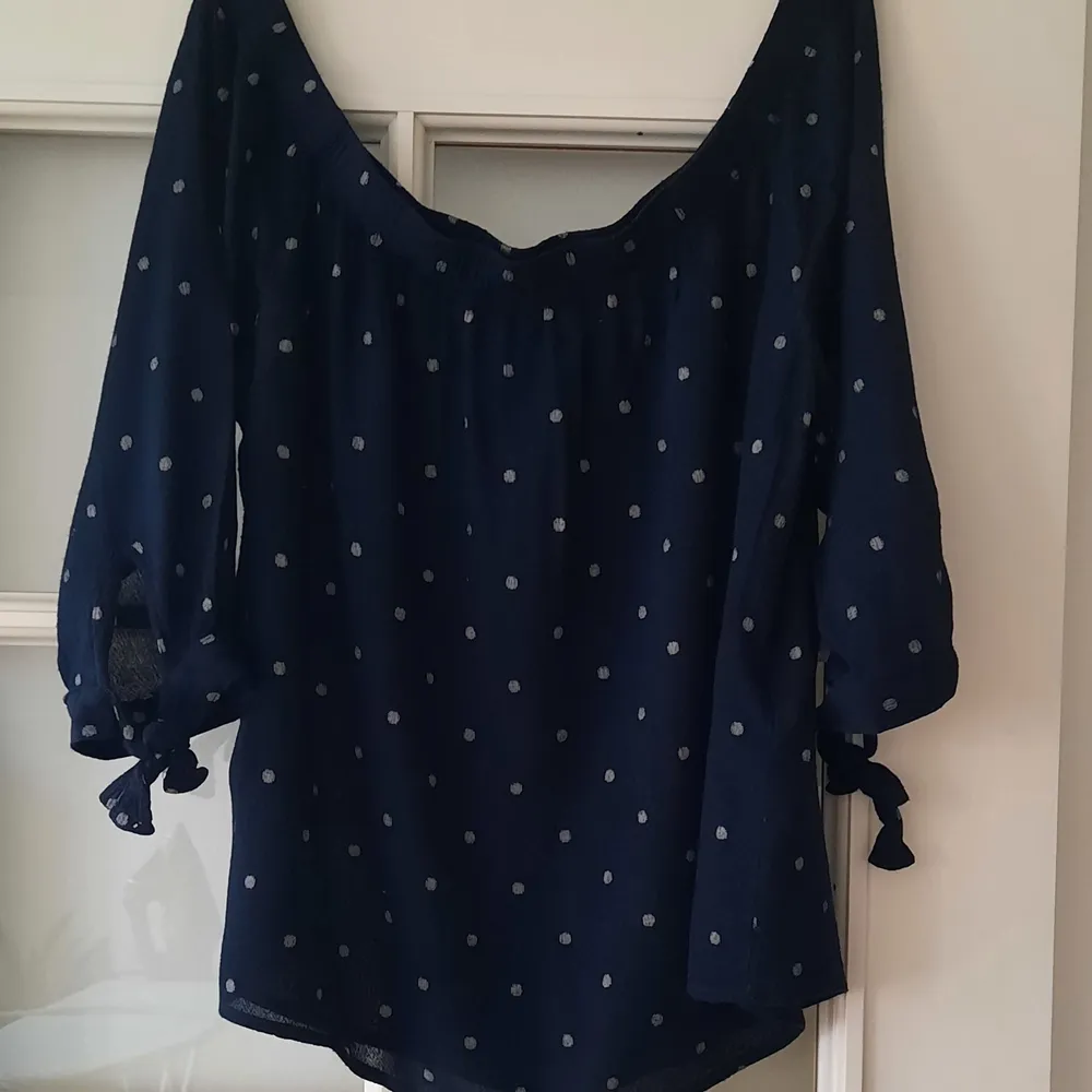 Dark blue polka dotted shirt from Vero Moda, Size S. Very cute detail with bows at the end of the sleeves. 100% Viscose.. T-shirts.