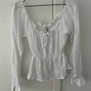 Topp från Nelly, strl 34 - Vit topp från Nelly i storlek 34. Enbart använd en gång.  Frakt ingår ej i priset. 