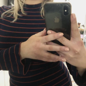 Klänning - Randig klänning med turtleneck och lite trumpet ärmar. 