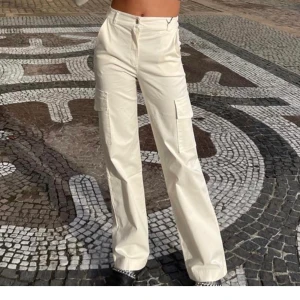 Cargo pants  - Säljer dessa sjukt snygga vita cargo pants från design by si.  Dom har fin passform och är i bra längd. Jag säljer den för att jag aldrig använder dem❤️jag har storlek s i dem och extra långa, passar också M😊