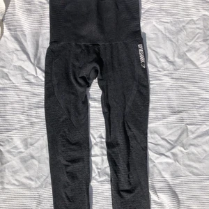 Gymshark leggings - Säljer ett par mörkgråa seamless leggings från gymshark. Perfekt skick förutom sprickor i märket som brukar förekomma efter första tvätten. Frakt via PostNord ingår. 