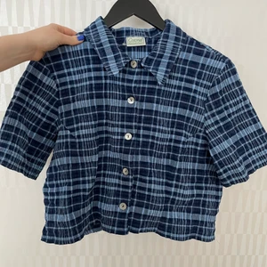 Croppad skjorta - Fin croppad blå kortärmad skjorta i ”vågigt” tyg. Passar S-L beroende hur man vill att den ska sitta 💙 (frakt ingår ej)