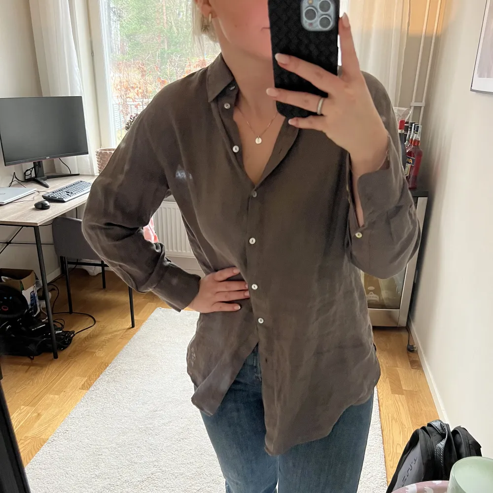 Linneskjorta i en oversized modell från Massimodutti i storlek 36. Grå/brun färg och använd 1 gång.  Superfin både till stranden men även till ett per jeans nu på våren 💗. Skjortor.