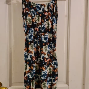 Klänning Vero Moda XS - Blommig klänning från Vero Moda i storlek XS. Storlek på uringning regleras beroende på hur hårt man knyter i nacken. Superfin till vita skor på sommaren.  Frakt tillkommer med 39 kr 🌞