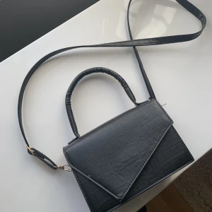 Svart Väska - Säljer min fina väska! Kommer ej ihåg vart den är köpt. Den är justerbar i bandet (se bild 3). Använd runt 2 gånger, som ny. Kom privat för mått 💓