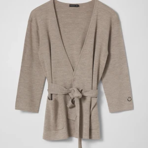 STOCKH LM Sienna cardigan - Stickad cardigan från Stockh lm, med fin struktur, fickor och avtagbart knytband i midjan. Koftan har en rak passform och trekvarts ärmlängd. Kvaliteten är en merinoullsblandning Använd 2 gånger Slutsåld, ord pris 799kr Storlek XS