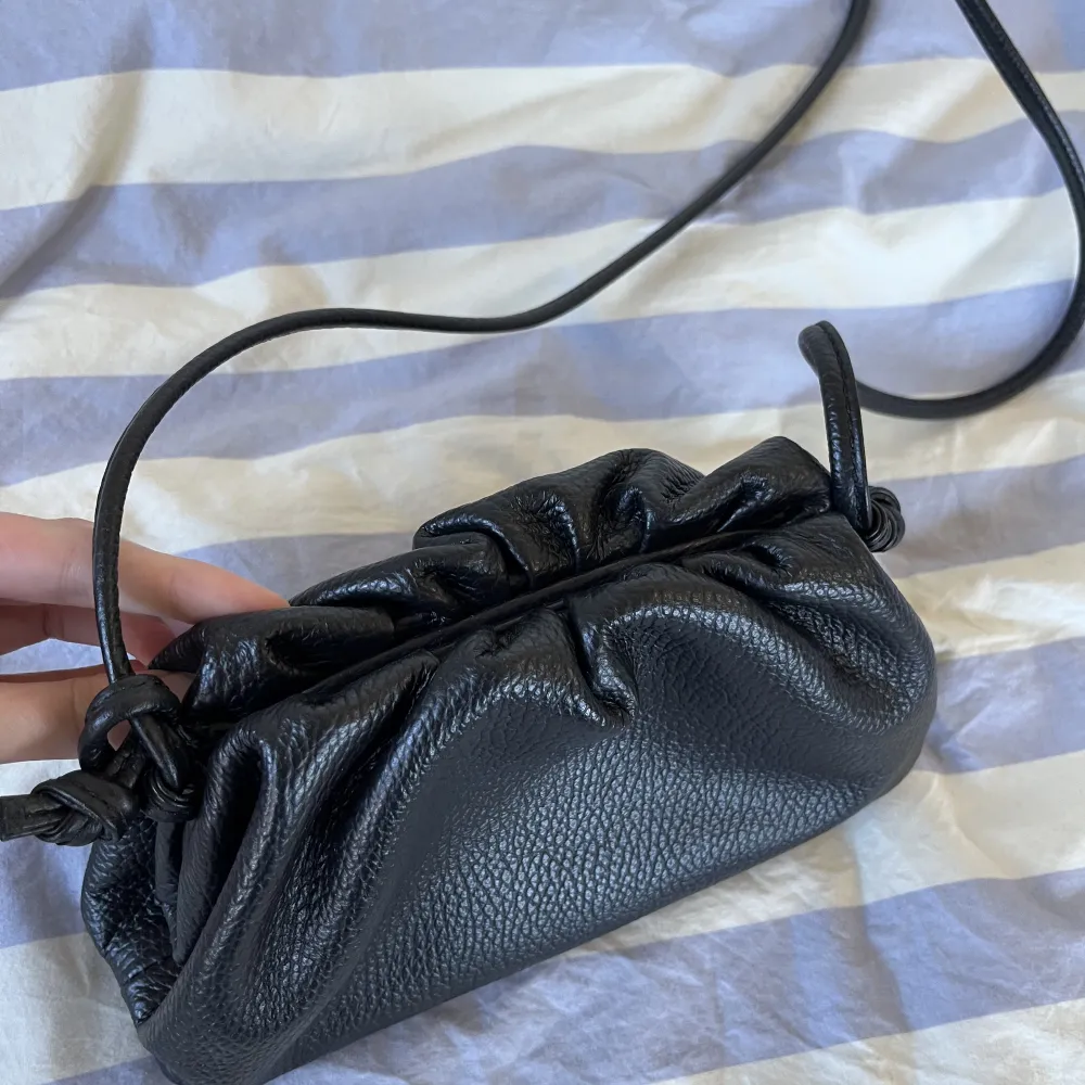 Säljer denna svarta bottega liknande väskan i italienskt läder. Den är köpt i Milano för ca 80€. Använd ett fåtal gånger så är helt i nyskick. Går att reglera axelbandet. . Väskor.