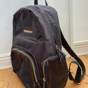 Ryggsäck Victoria Secret - Svart ryggsäck från Victoria Secret med gulddetaljer, rosa innerforder. Fint skick, knappt använd.