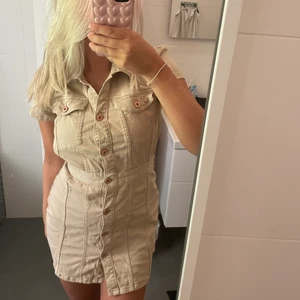 Klänning - Klänning i beige denim. Man kan knäppa knapparna hur man vill där fram. Köpt på zara för något år sedan. Använd en gång, storlek XS💞