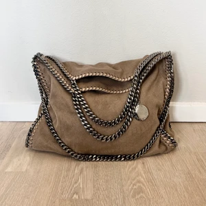 Stella McCartney - Säljer min Stella McCartney väska i modellen Falabella Fold-Over Tote. Väskan är använd ett fåtal gånger, har inga tecken på användning och är i nyskick.   Nypris 9880kr Storlek: 37x36x9  Kan mötas upp i Stockholms innerstad eller skicka med PostNord.  