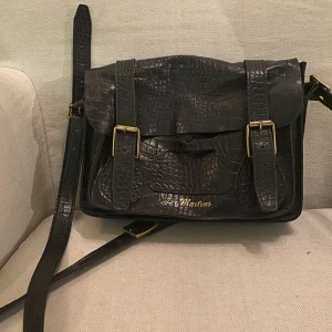 Dr Martens väska - Fin rymlig väska från Dr Martens, i gott använt skick. Äkta läder. Nypris var runt 2200kr. Köpt för ett antal år sen