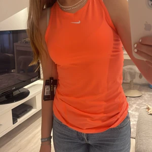 Nike tränings linne stl. Xs - Jag säljer ett rosa/orange tränings linne ifrån nike Stl. Xs men passar S. Aldrig andvänt och lappar sitter kvar.    På sista bilden ser ni en liten liten prick på linnets innre sida som jag aldrig sett. Ny pris - ca 250kr Mitt pris - 150kr