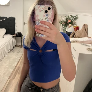 Blå topp - Blå oandvänd topp med prislapp kvar. Har utskärningar vid brösten 