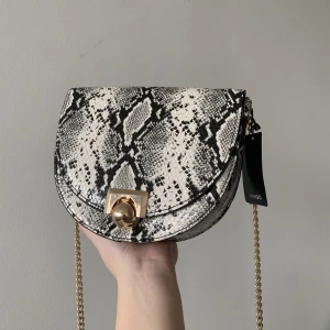 Oanvänd väska från Mango - Oanvänd axelremsväska från Mango med snakeprint. 