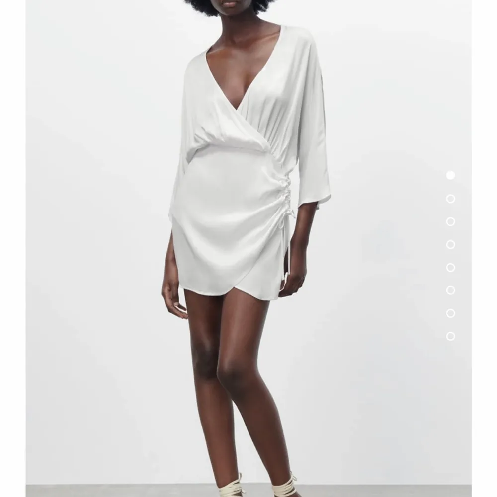 Superfin vit klänning i silkigt material från Zara. Helt ny med lappar kvar. . Klänningar.