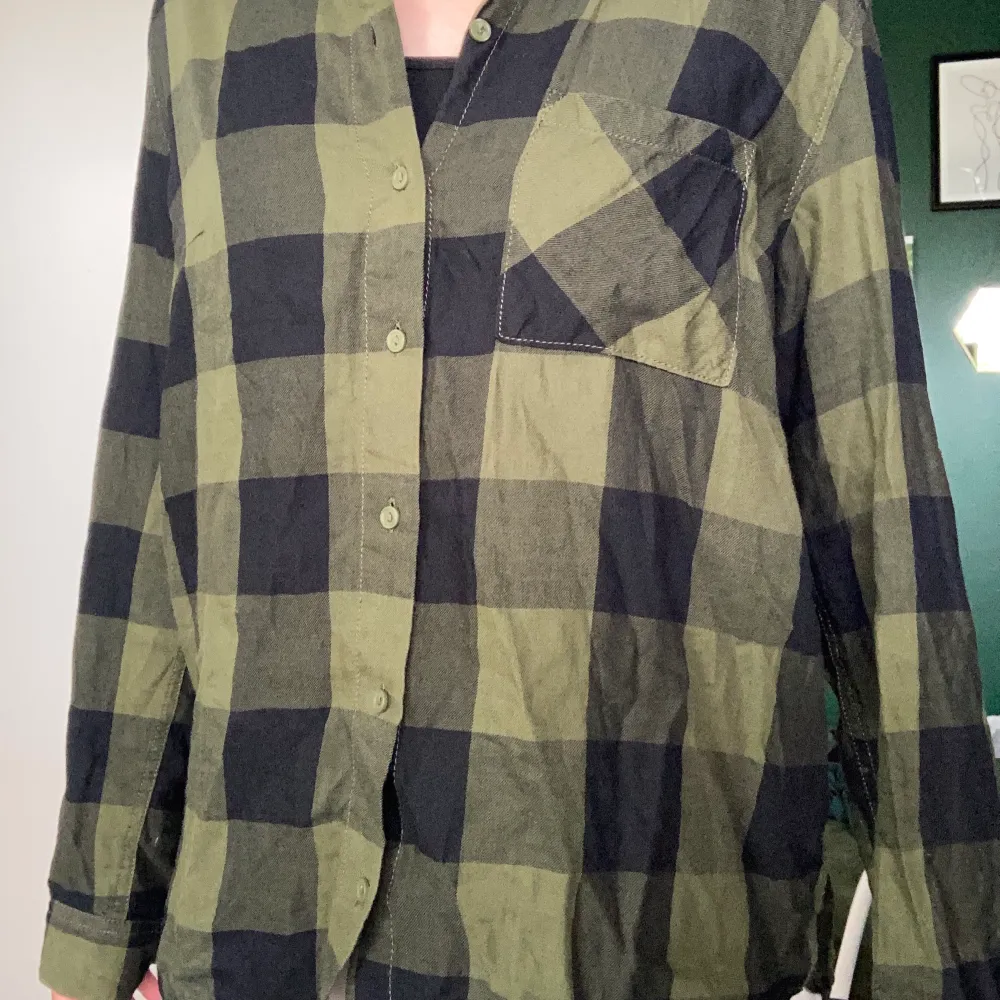 Grön och svart skjorta från divided i stl S. Har används några gånger men det var länge sedan sist. Köparen står för frakt.. Skjortor.