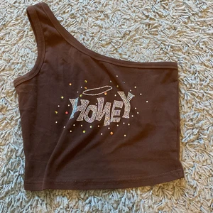 Asymmetriskt linne - Brunt linne men fint tryck. Knappt använd. Strl Xs