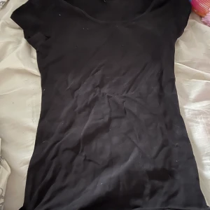 T-shirt  - En vanlig svart t-shirt, sparsamt använd och inga synliga slitage 