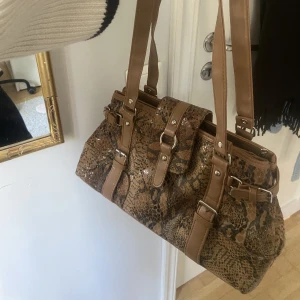 Cool väska - Jättebra skick men känns lite plastig i materialet. Vet ej märket då det inte står och jag köpte den second hand. Skriv för fler bilder/info!