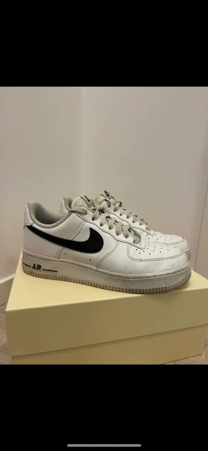 NIKE AIR FORCE 1  - Nike air force i storlek 40 med ett svart Nike märke på sidan. Köparen står för frakt.
