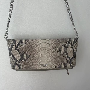 Zadig Voltaire rock clutch  - Säljer min fina Zadig Voltaire rock clutch i snakeprint. Väldigt fint skick använd fåtal gånger. Två olika straps. 