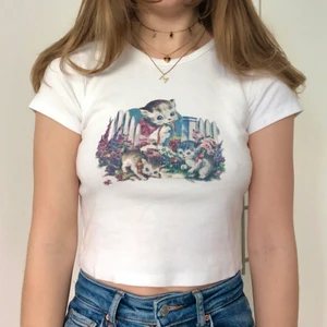 Brandy Melville topp - Topp/t-shirt med katt tryck från Brandy Melville 🐈 Använd fåtal gånger så är i mycket bra skick ☘️ Ingen storlek står men uppskattas till XS-S 