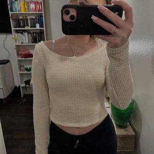 Beige stickad offshoulder tröja - Säljer en snygg beige stickad offshoulder tröja. Den är croppad och är  perfekt för en varm dag  Passar bra till både jeans och kjol, Men passar bäst med strand kläder 