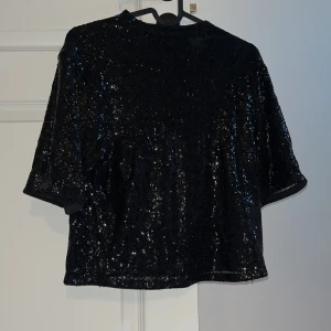 Svart paljettopp från H&M XS - Glittrig svart topp från H&M i storlek XS, täckt med paljetter. 