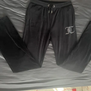 Svarta mjukisbyxor med strassdetalj - Säljer även dessa svarta juicy byxor eftersom att även dom inte passar längre, byxorna har små fläckar men inget man lägger märke till, jag har endast använt byxorna ett fåtal gånger och utöver fläckarna är byxorna i väldigt bra skick, pris kan diskuteras.