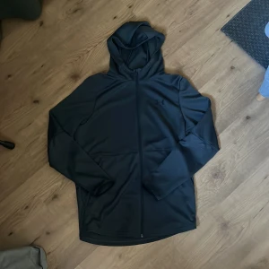 Grå träningsjacka från Under Armour - Grå träningsjacka från underarmour som är lite för stor för mig