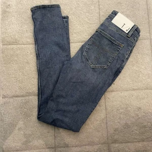 Tiger of sweden jeans  - Säljer ett par klassiska tiger of sweden jeans i ljusblå tvätt. Modellen är slim fit med raka ben och normal midja. Jeansen har fem fickor, dragkedjegylf och är tillverkade i mjukt bomullsjeans. Perfekta för en avslappnad och stilren look.