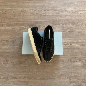 Svarta sneakers med vit sula - Snygga svarta sneakers med en kontrasterande vit sula. Skorna har snörning och en stilren design som passar perfekt till vardags. Perfekta för dig som vill ha en klassisk look med en modern touch.