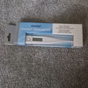 Digital termometer  - Ingen bok syns på bilderna, endast en digital termometer från Valmed i förpackning. Ingen information om boktitel, författare eller innehåll kan utläsas.